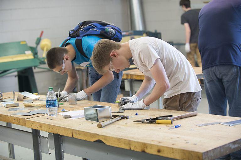Students work at a workbench.